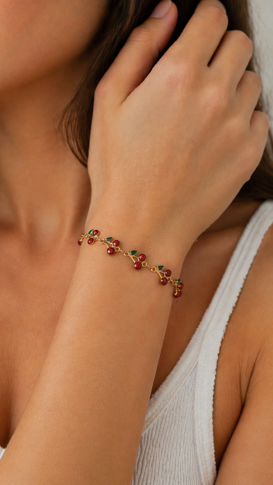 Close-up of a hand wearing a colorful bracelet on a neutral background