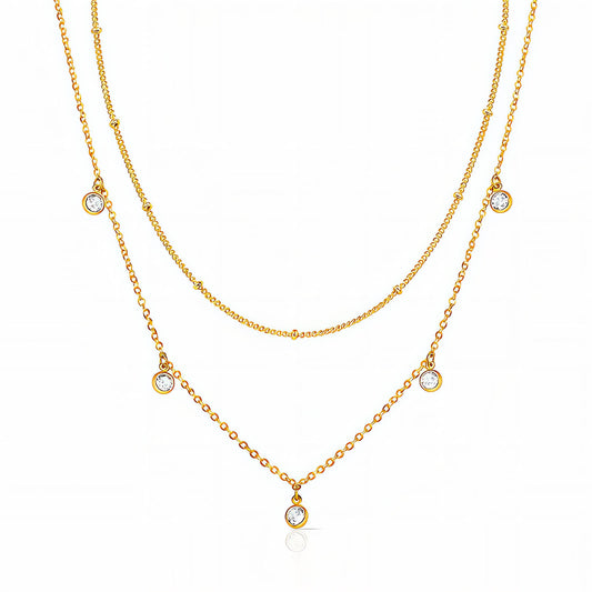 Two gold necklaces with small gemstones on a white background