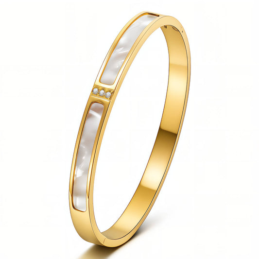 Gold bracelet with a white interior on a white background