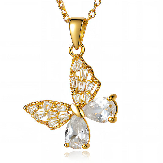 Gold butterfly pendant necklace with clear gemstones on a white background