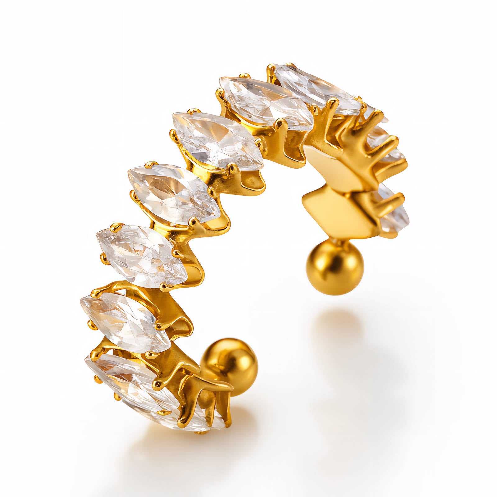 Gold and clear crystal earring on a white background