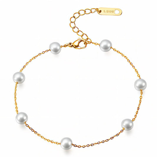 Gold bracelet with pearls on a white background