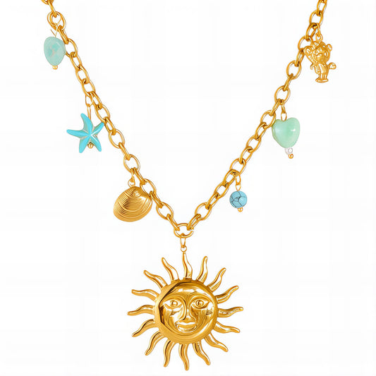 Gold necklace with sun pendant, starfish, shell, and turquoise beads on a white background