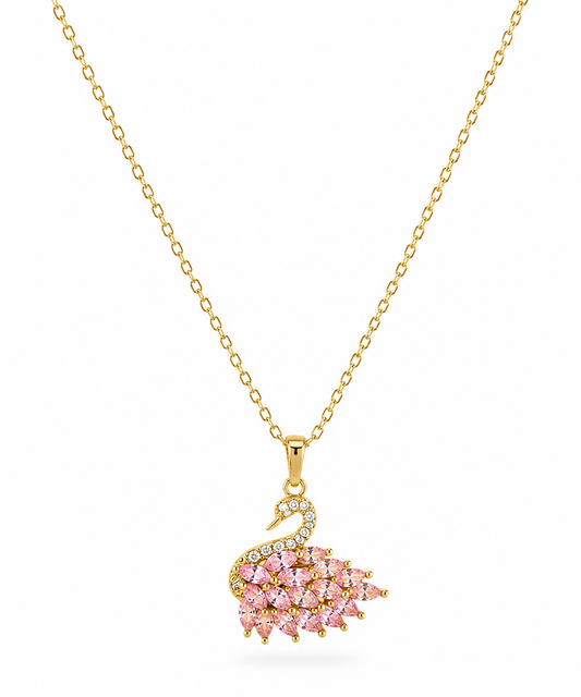 A gold chain necklace featuring a swan pendant embellished with pink gemstones and small clear stones, displayed on a clean white background.