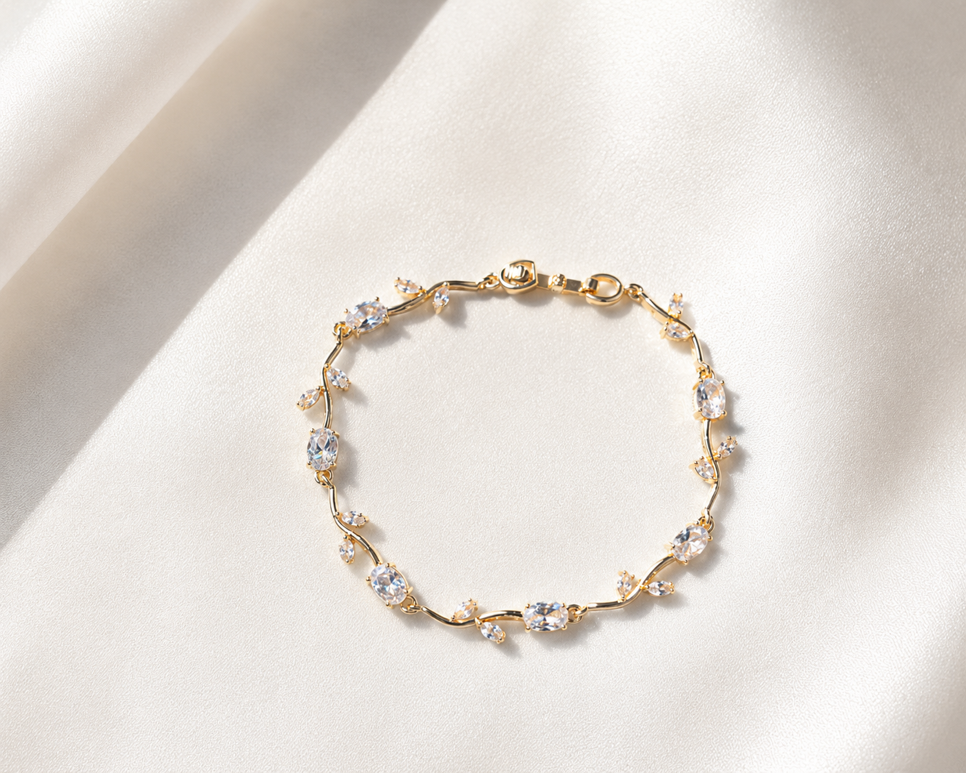 Gold bracelet with crystals on a white background