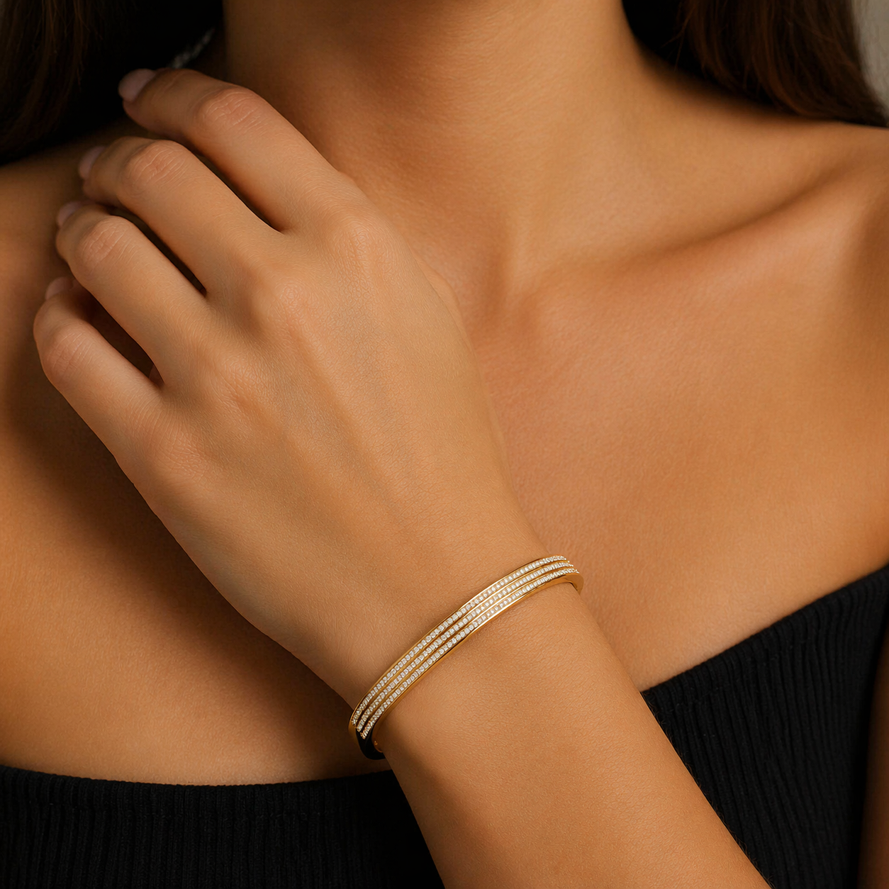 Gold bracelet on a person's wrist with a blurred background