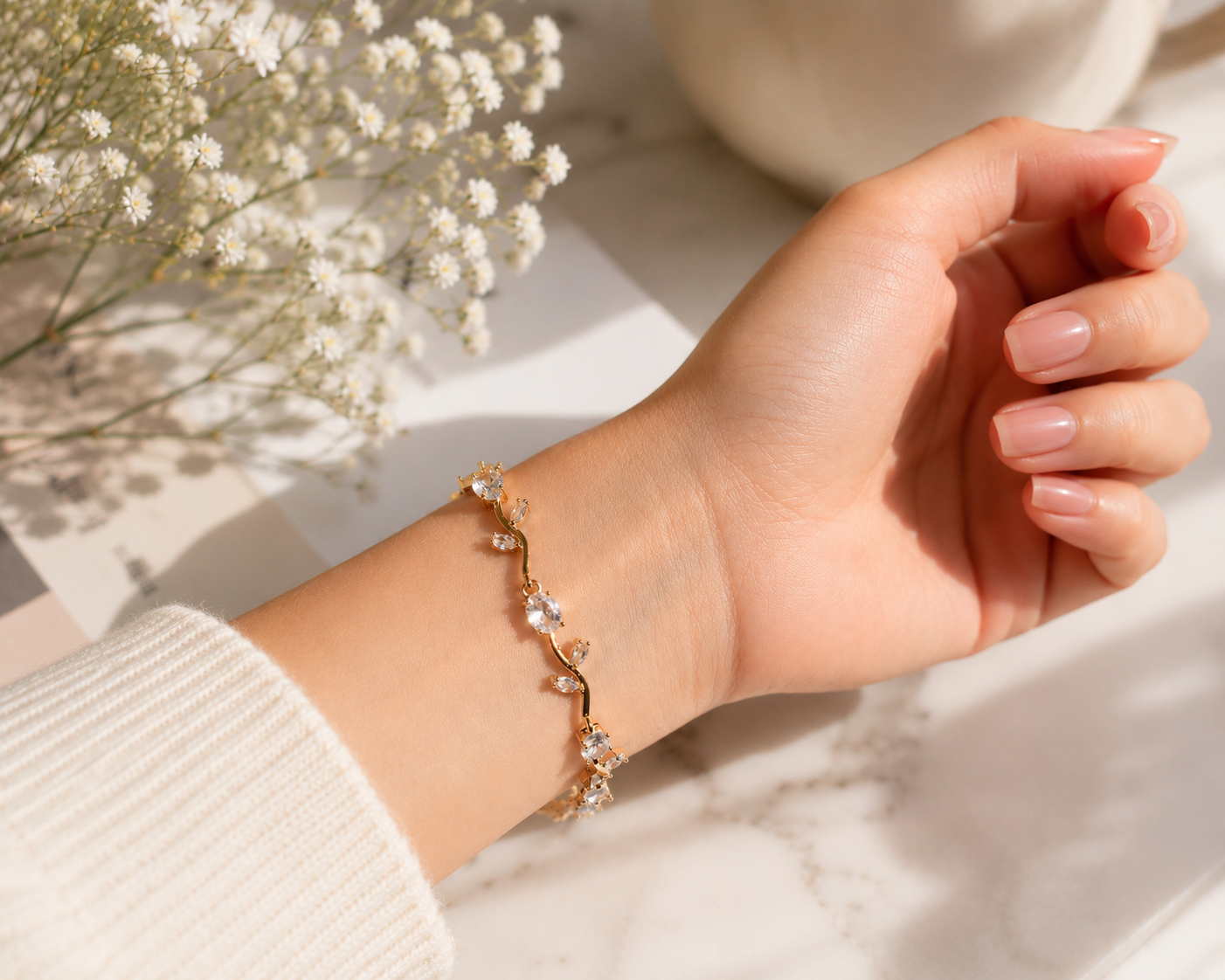 Hand wearing a delicate bracelet with a soft background