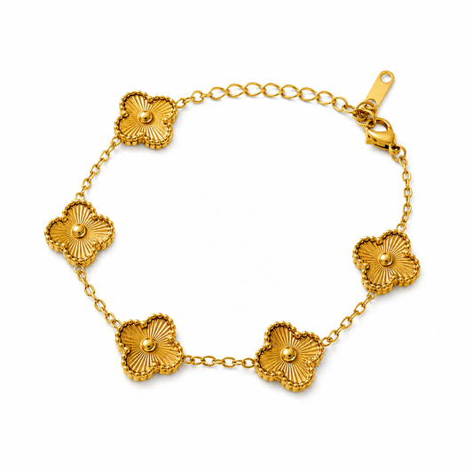 Gold bracelet with floral designs on a white background