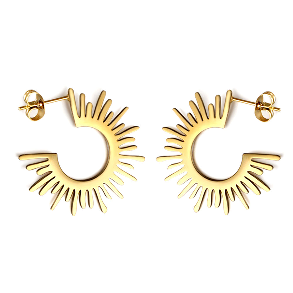 Gold hoop earrings with a sunburst design on a white background